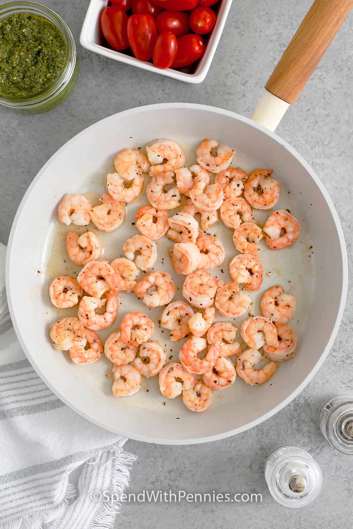 A skillet of cooked shrimp to make Shrimp Pesto Pasta