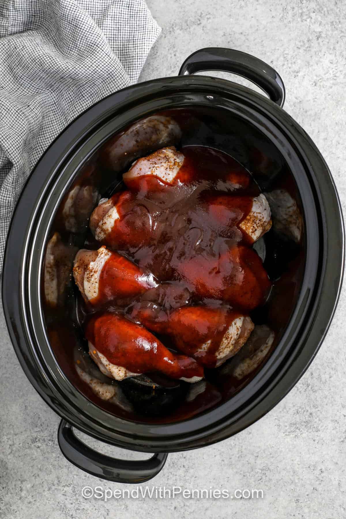 adding sauce to chicken in slow cooker to make Slow Cooker Chicken Drumsticks
