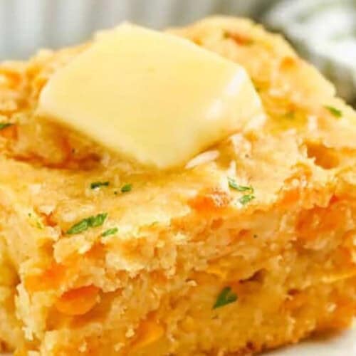 close up of cornbread casserole with butter