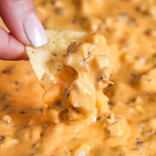 dipping a chip in Sausage Cheese Dip