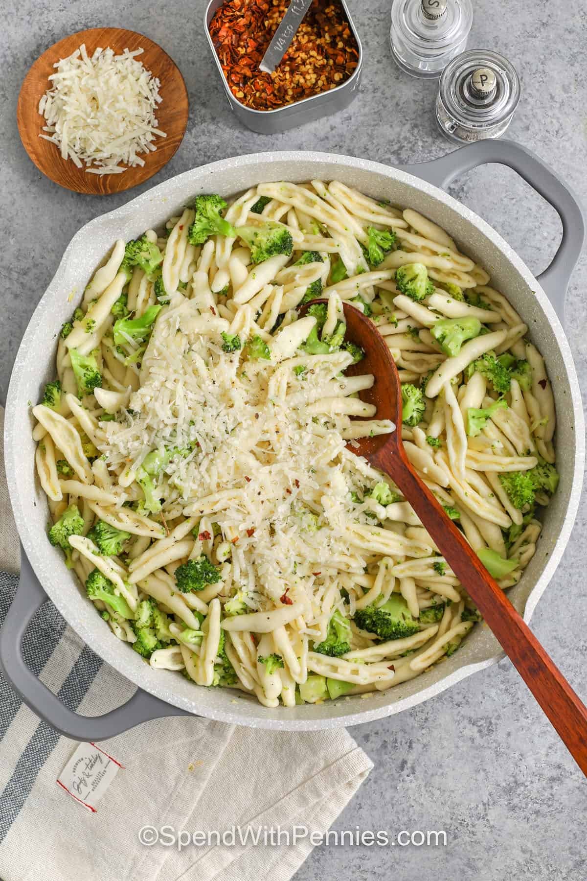 adding parmesan pan to make Cavatelli and Broccoli