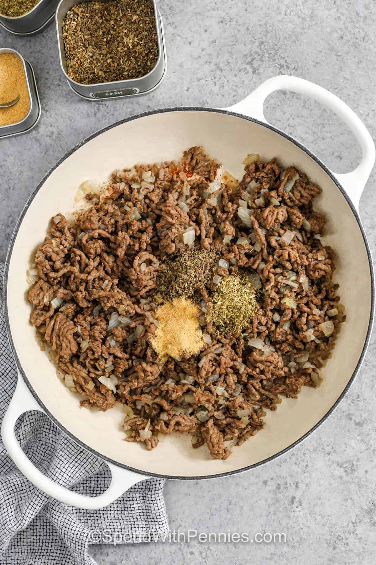 adding seasonings to beef and onions to make Creamy Ground Beef Pasta