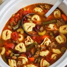 Crockpot Tortellini Soup in crockpot with a ladle
