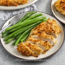 french onion baked chicken on a white plate with a fork