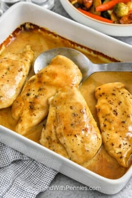 Honey Mustard Chicken in a casserole dish with a spoon