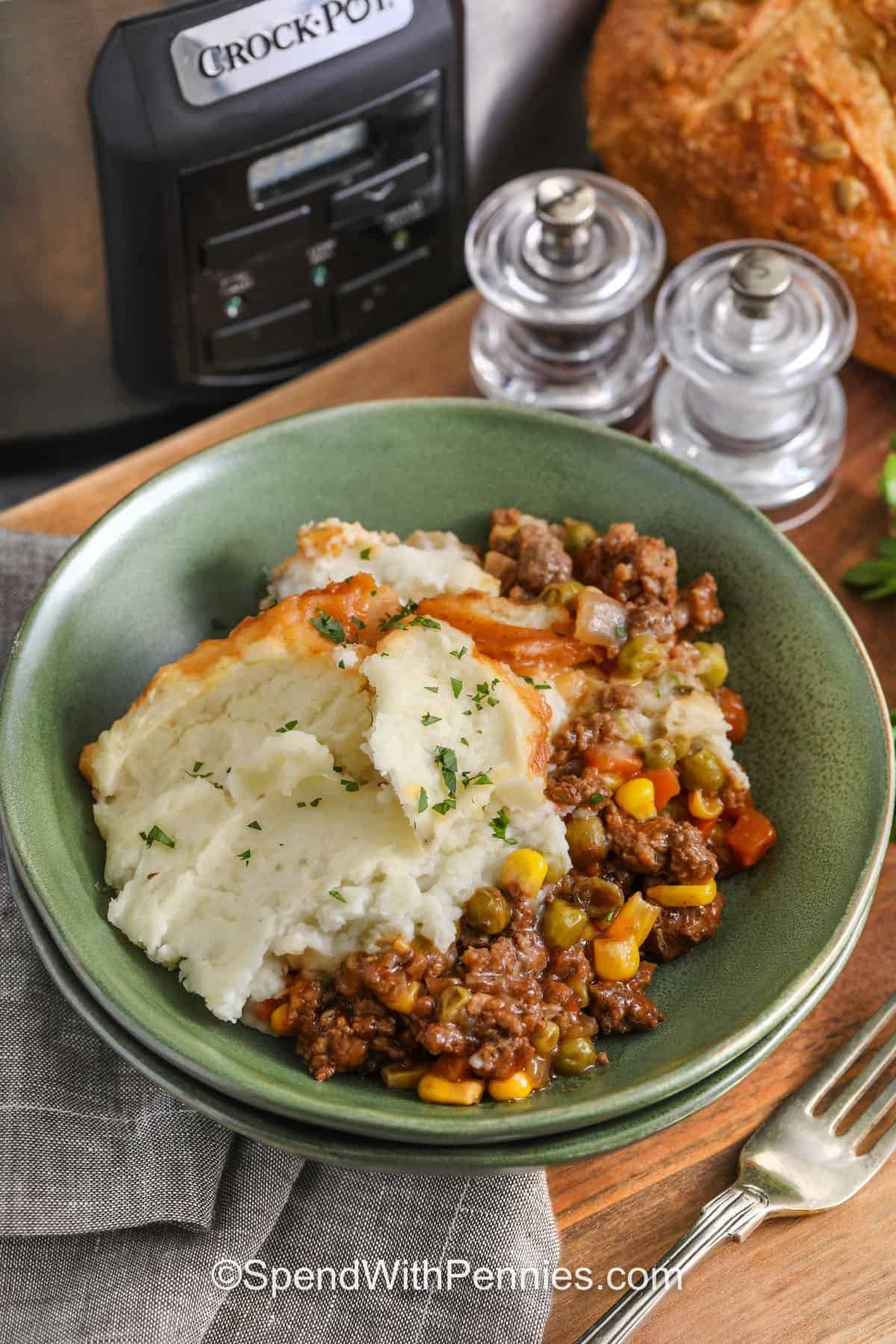 This easy slow cooker shepherd's pie has everything in one pot: seasoned meat, vegetables, and a gravy-style sauce under a thick mashed potato layer. Brown the beef or lamb with onion, then whisk the sauce until smooth so the cornstarch dissolves fully. Spread the mashed potatoes on top and do not stir. Resting time helps the gravy set for a hearty, scoopable texture. #spendwithpennies plated Slow Cooker Shepherd's Pie