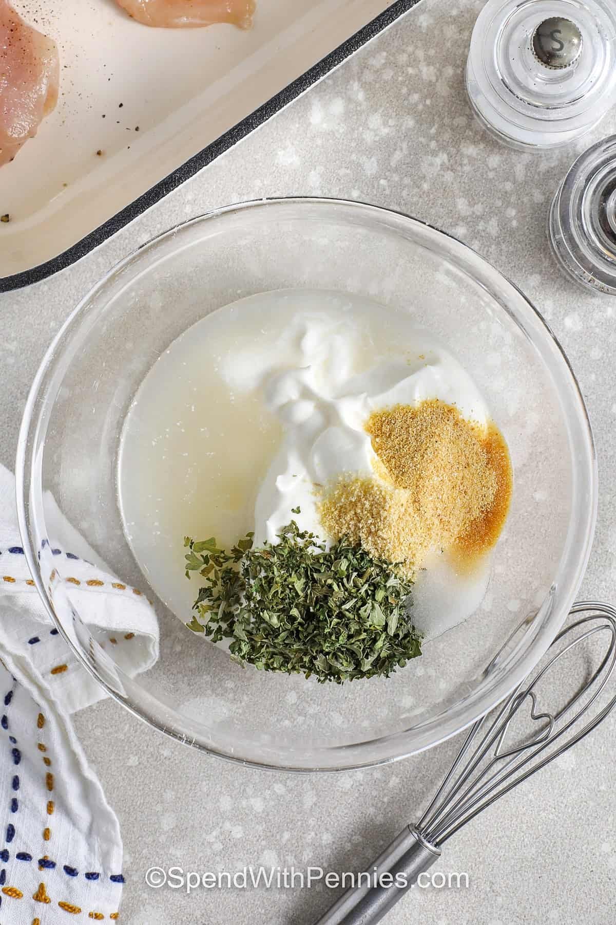 adding seasonings and broth to sour cream to make Sour Cream Chicken