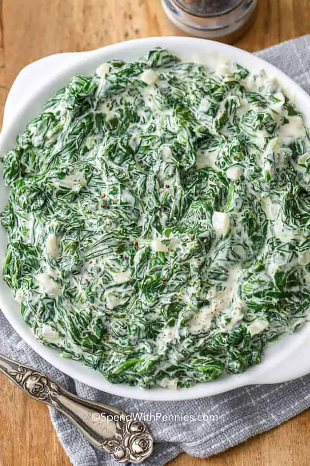 This steakhouse creamed spinach recipe turns everyday ingredients into a rich, creamy spinach side dish. Onion cooks until tender, then cream cheese and heavy cream create a smooth sauce that clings to the spinach. Fresh or frozen spinach both work, but removing extra liquid keeps the sauce from getting thin. Serve it alongside ribeye or baked chicken, then warm leftovers gently for a silky repeat. #spendwithpennies plated Creamed Spinach 2