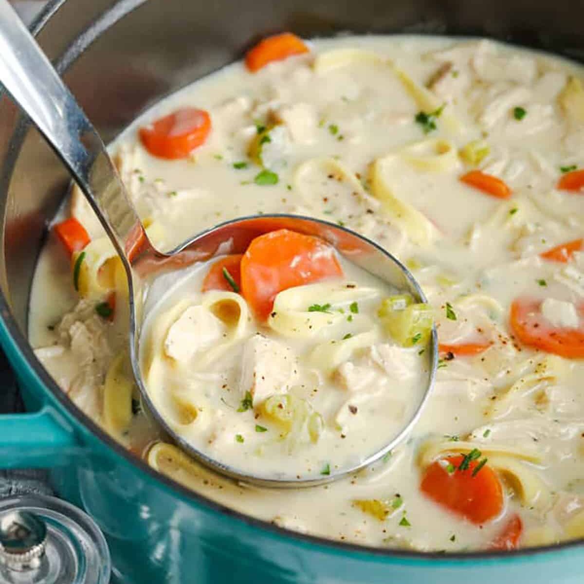 Creamy Chicken Noodle Soup in the pot with a ladle