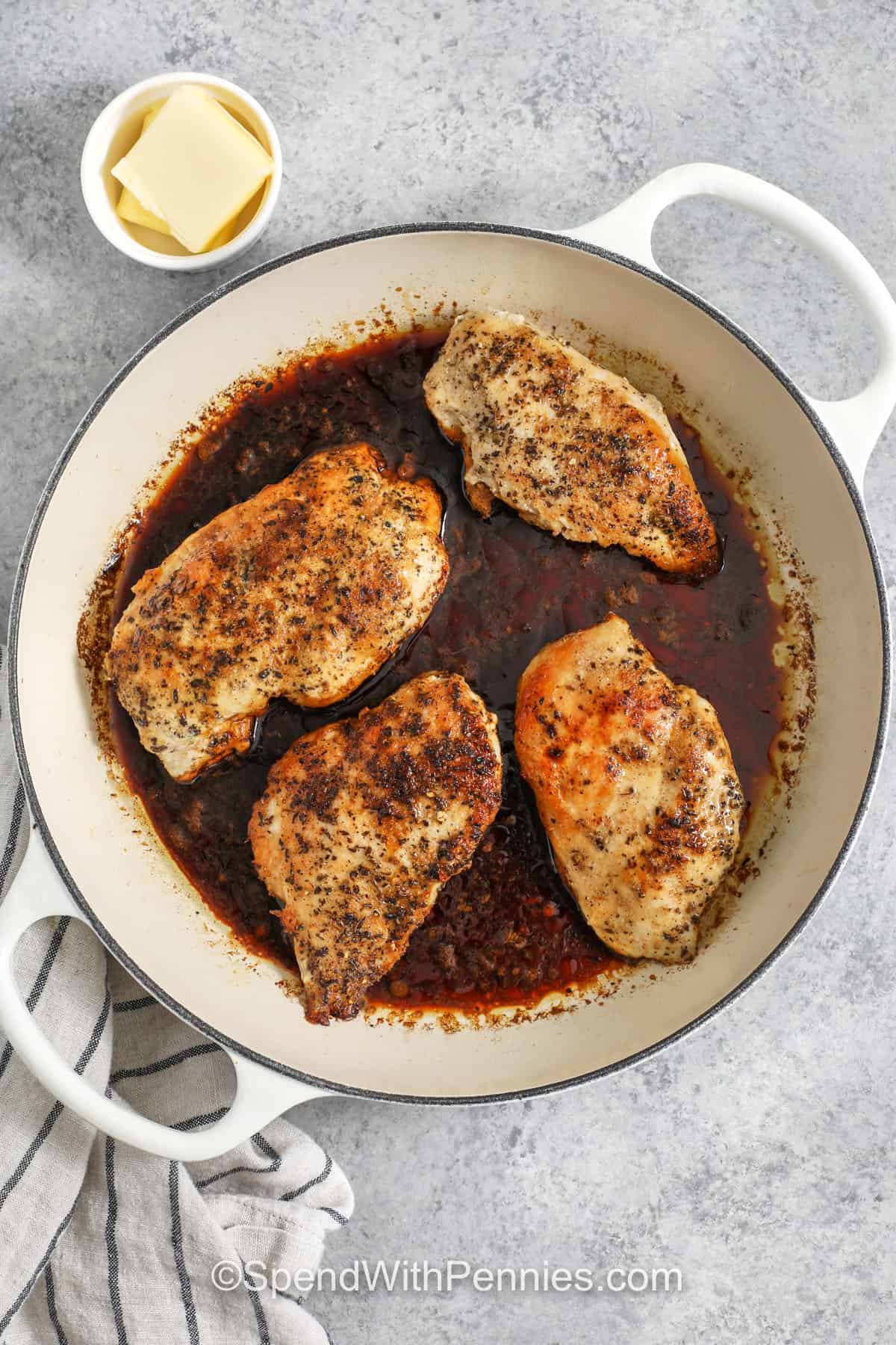 This balsamic chicken recipe is sweet, tangy, and perfect for spooning over your favorite sides. Seasoned chicken breasts are pan-seared until golden, then simmered with balsamic vinegar and honey to build a rich glaze. Butter stirred in at the end makes the sauce silky and flavorful. Great for weeknights, and leftovers are perfect sliced over salads or rice bowls. #spendwithpennies cooking chicken with balsamic sauce to make Balsamic Chicken