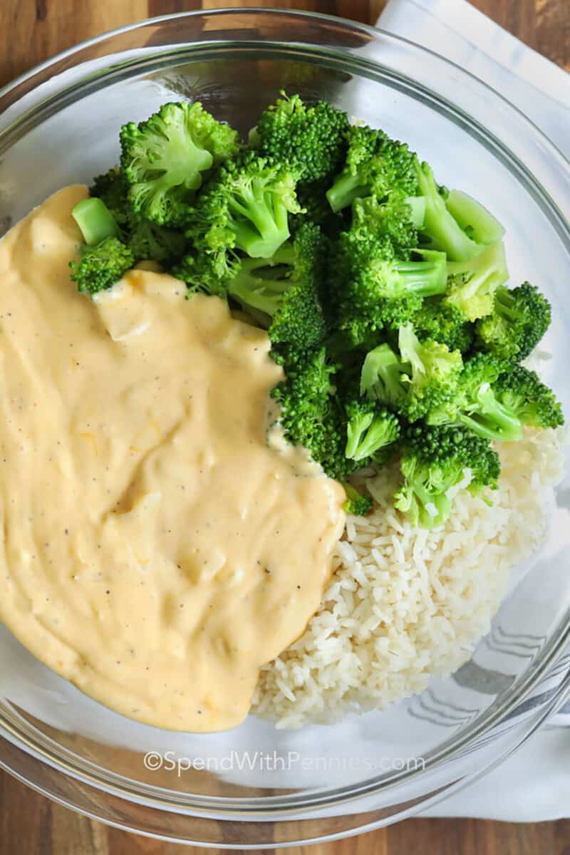adding ingredients to bowl to make Broccoli Rice Casserole from Scratch