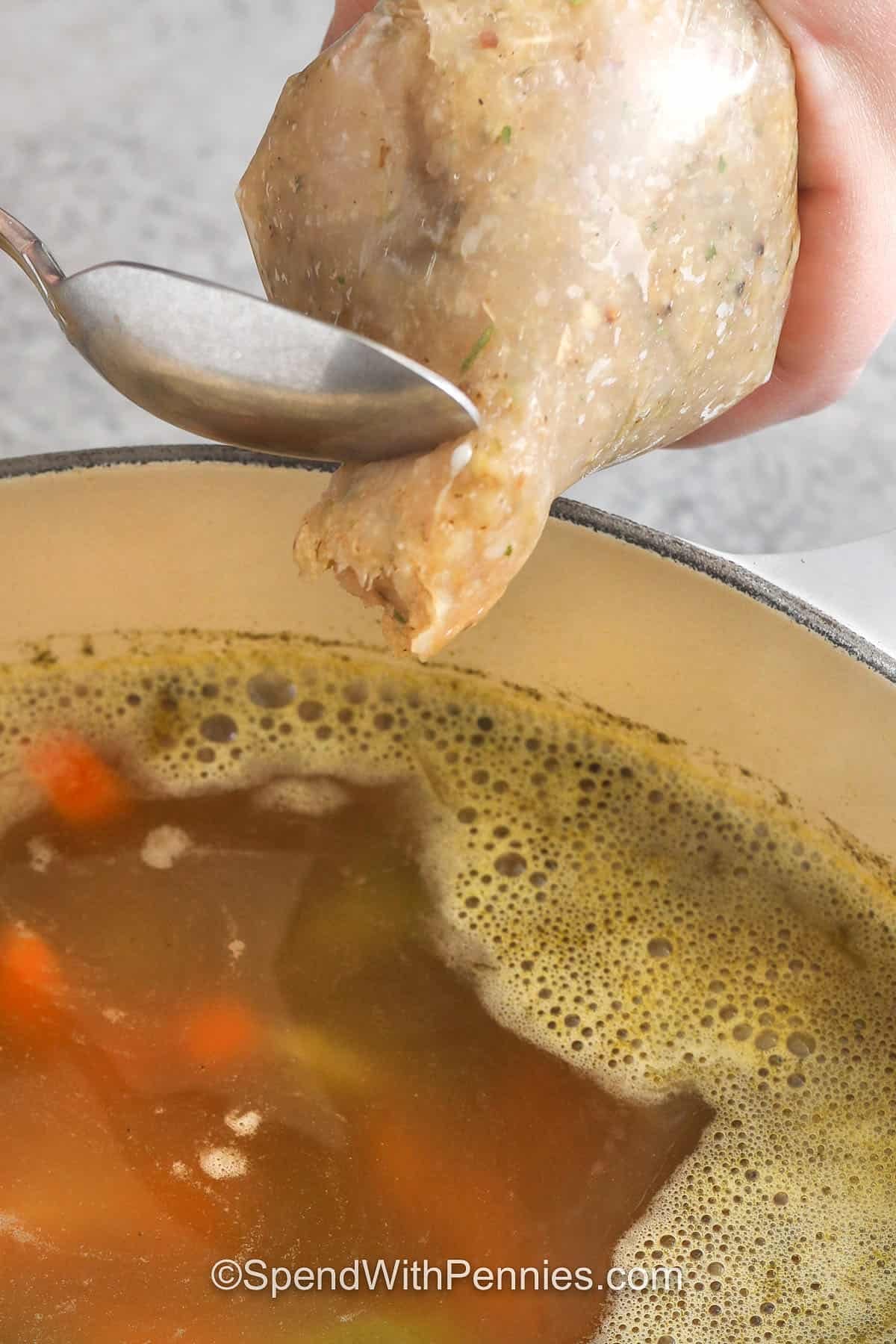 adding chicken meatballs to soup to make Chicken Meatball Soup