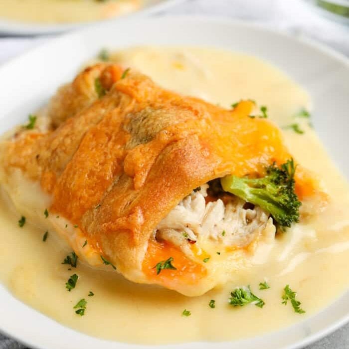 Chicken Roll Ups close up on a white plate with sauce