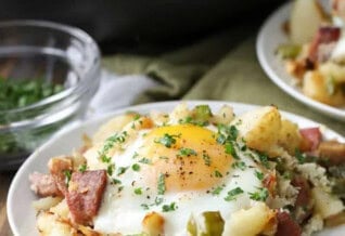 Corned Beef Hash on a plate and pan full in the back