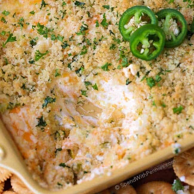 Jalapeno Popper Dip served with crackers and garnished with fresh jalapeno slices