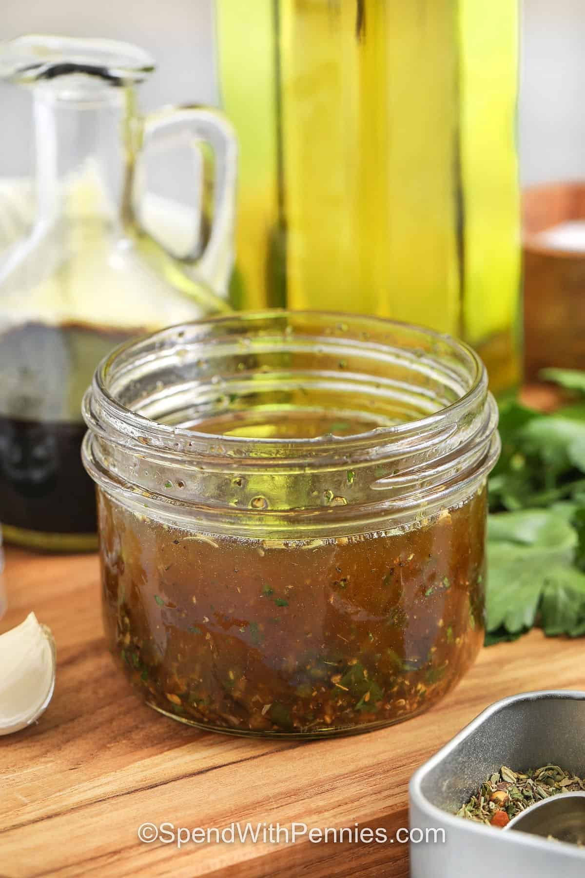 This olive oil bread dip is a simple way to start pasta night or serve guests without extra dishes. Extra virgin olive oil, balsamic, garlic, and Italian herbs create a savory, tangy dip that feels restaurant-style at home. Finish with grated Parmesan for a salty bite and serve with warm sliced baguette, focaccia, or toasted crostini. #spendwithpennies Olive Oil Bread Dip in a jar