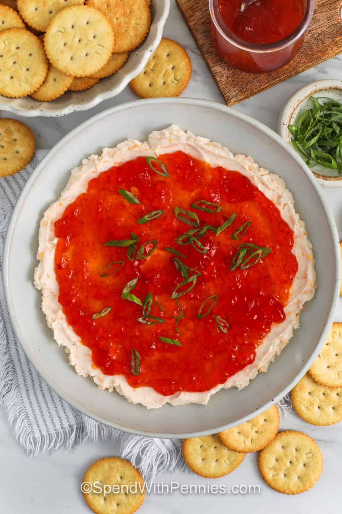 top view of pepper jelly cheese dip in a gray bowl