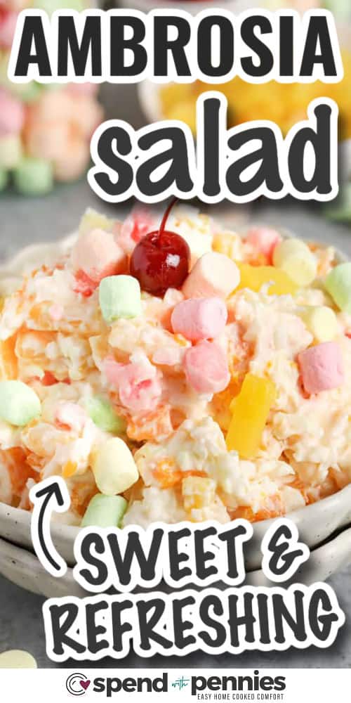 Make ambrosia salad in minutes for a nostalgic side that doubles as dessert. Mini marshmallows and coconut create that signature fluffy texture, while pineapple and mandarin oranges keep it bright and juicy. For best results, drain the fruit very well and let the bowl chill at least 4 hours so the base thickens and the flavor balances out. It serves a crowd and is easy to double. #spendwithpennies sweet and refreshing Ambrosia Salad in a bowl with writing