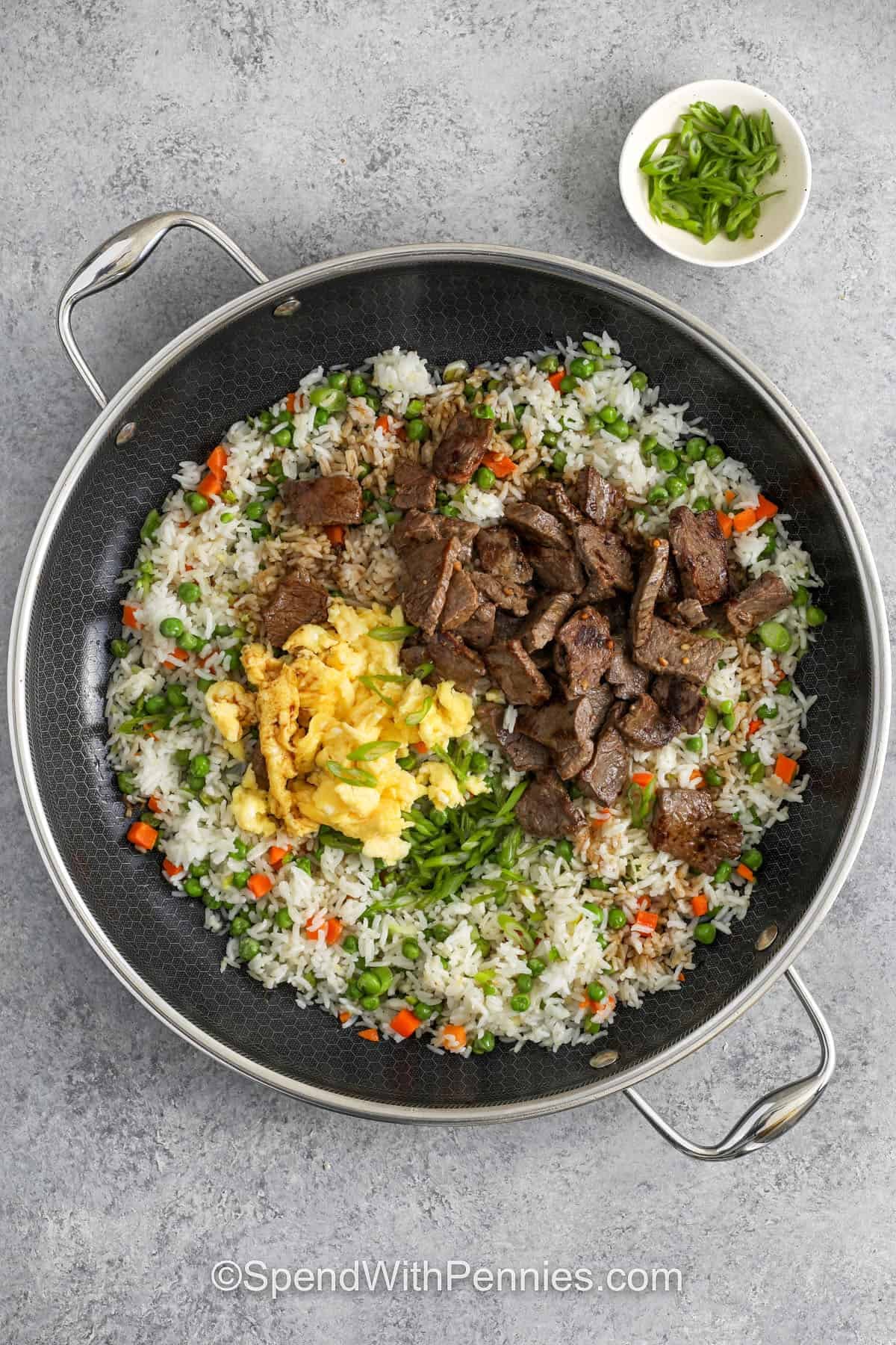 adding egg and steak to pan to make Steak Fried Rice