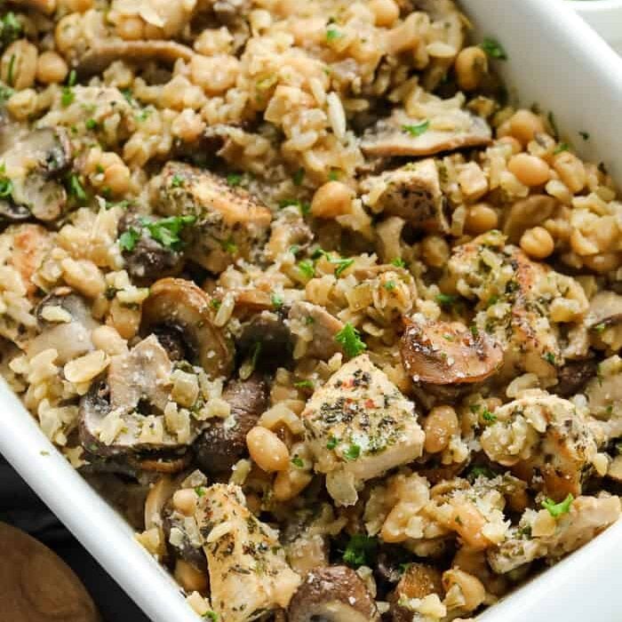 Chicken mushroom casserole in a white dish with parsley