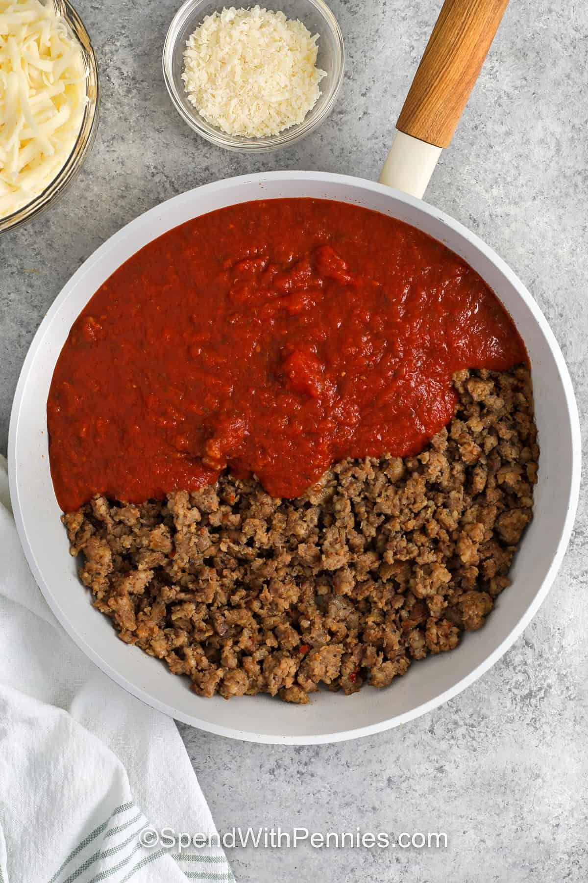 adding marinara to ground beef to make sauce for Ravioli Lasagna