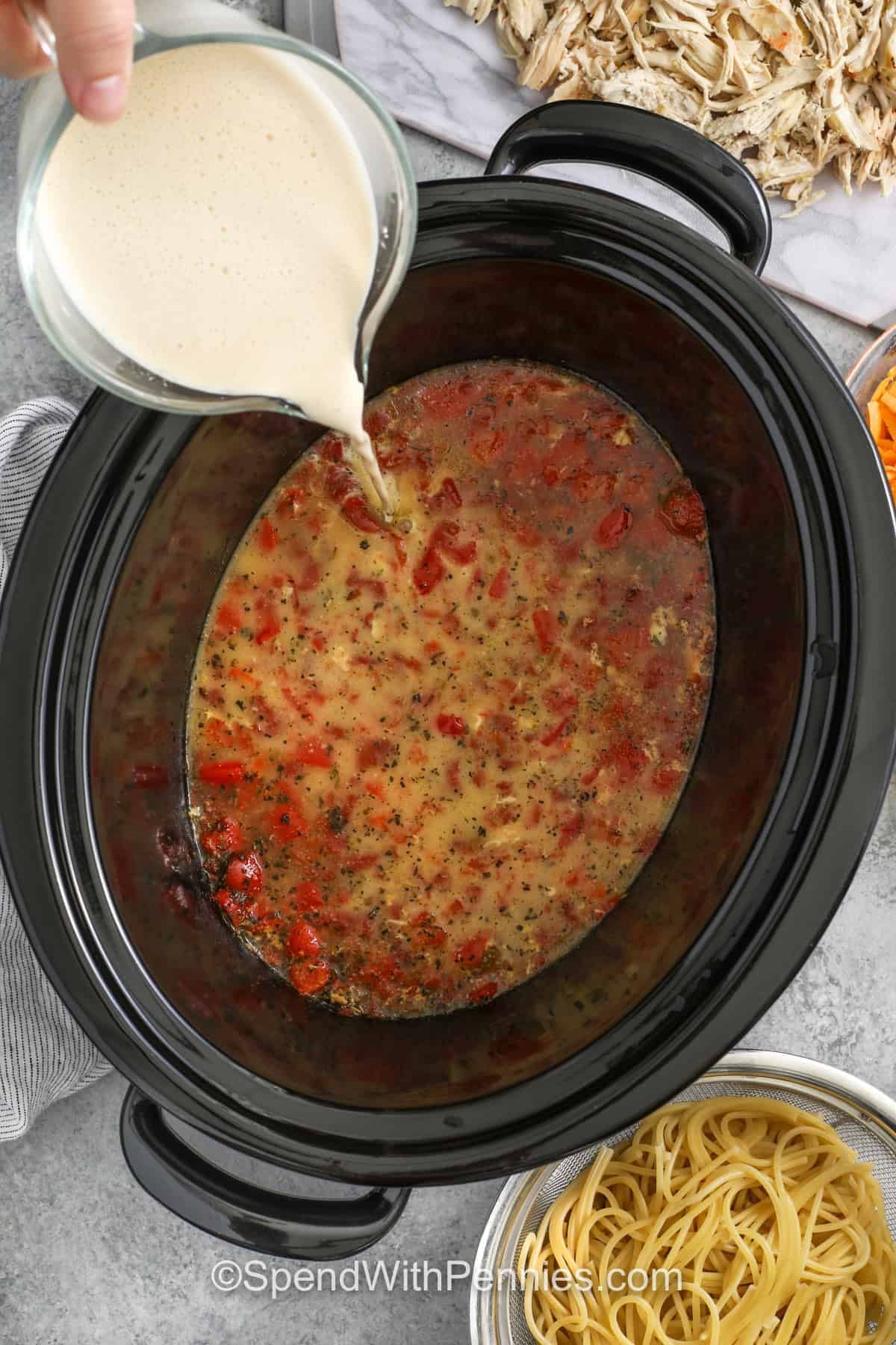 adding milk to pot to make Crockpot Chicken Spaghetti