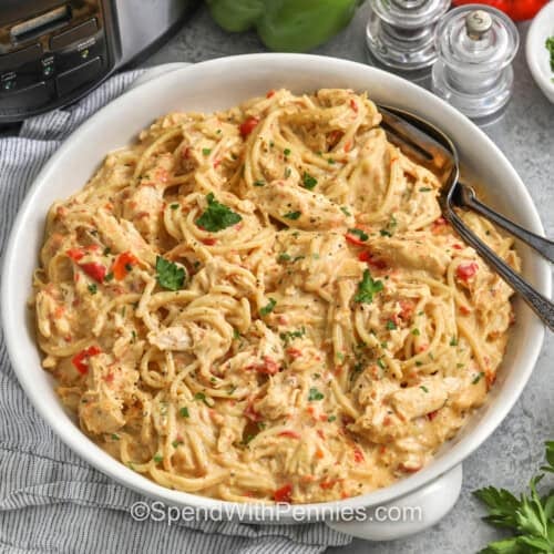 bowl of Crockpot Chicken Spaghetti wih a fork and spoon