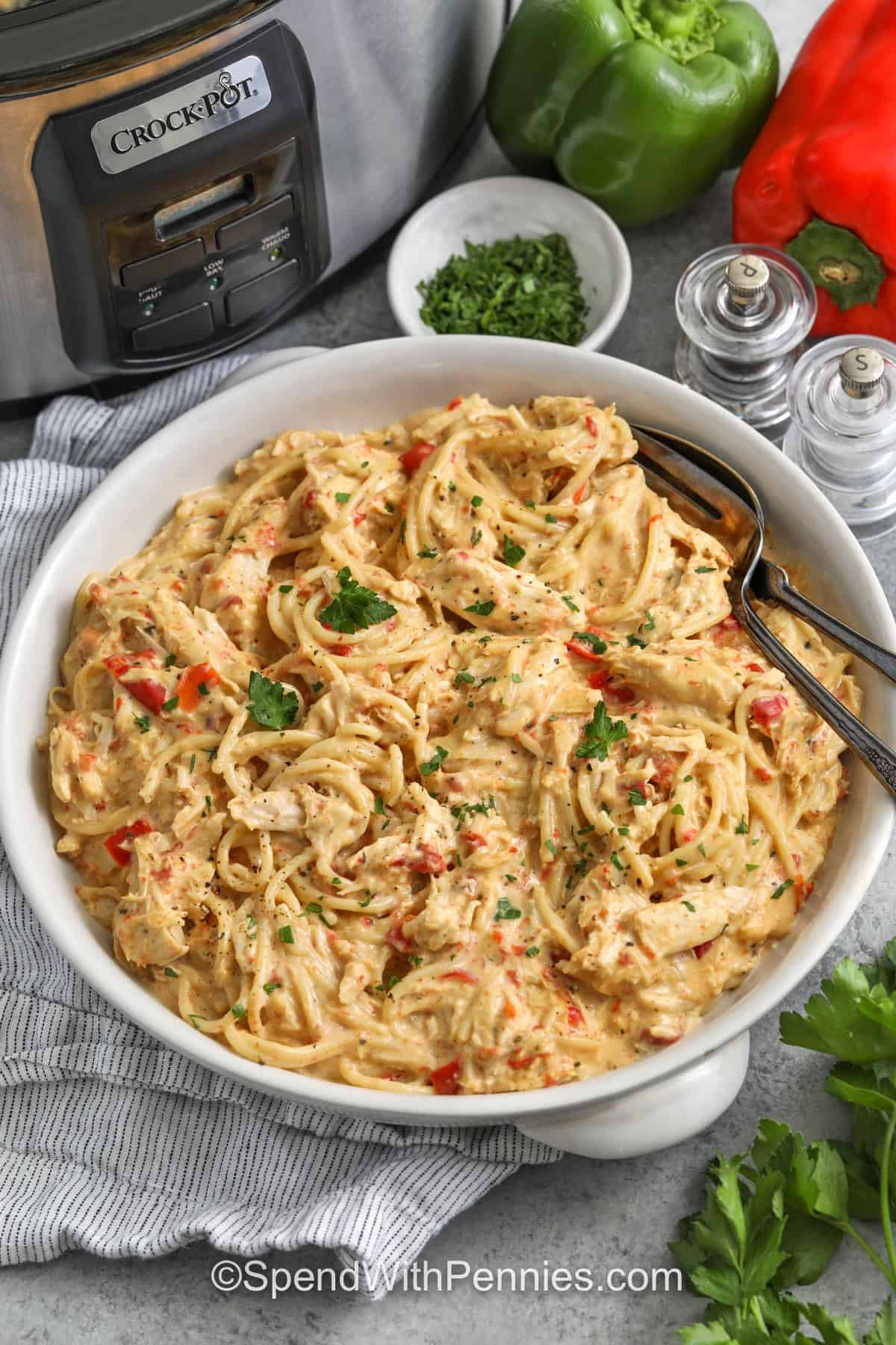 plated Crockpot Chicken Spaghetti with crockpot in the background