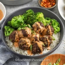 firecracker meatballs in a bowl with rice and broccoli and sauce
