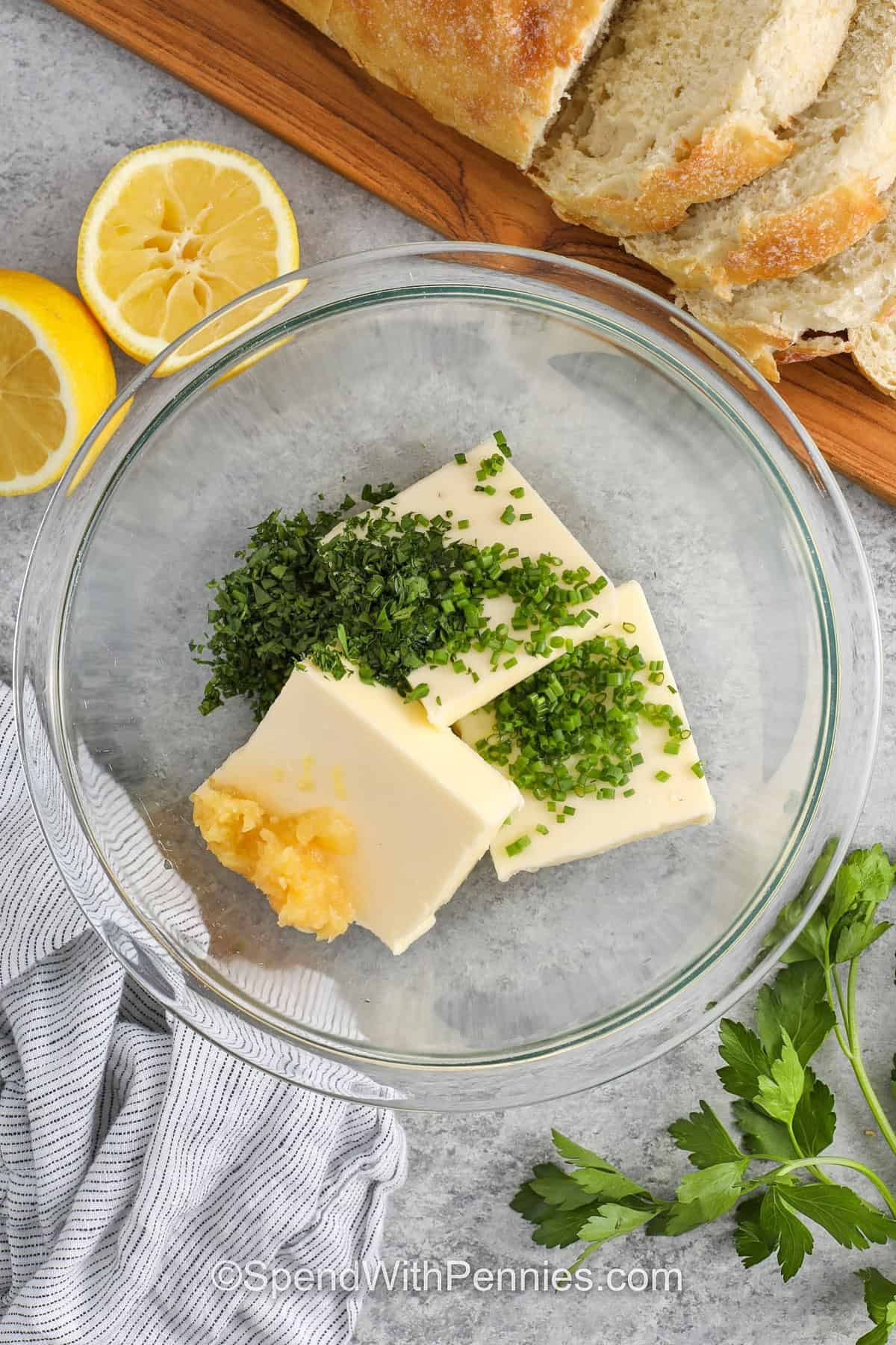 adding garlic , chives and parsley to butter to make Garlic Butter Recipe