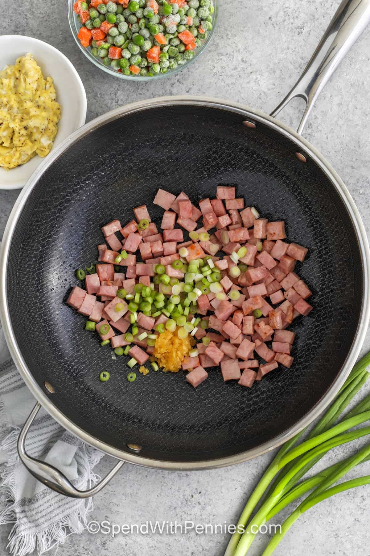 ham and green onions in a skillet