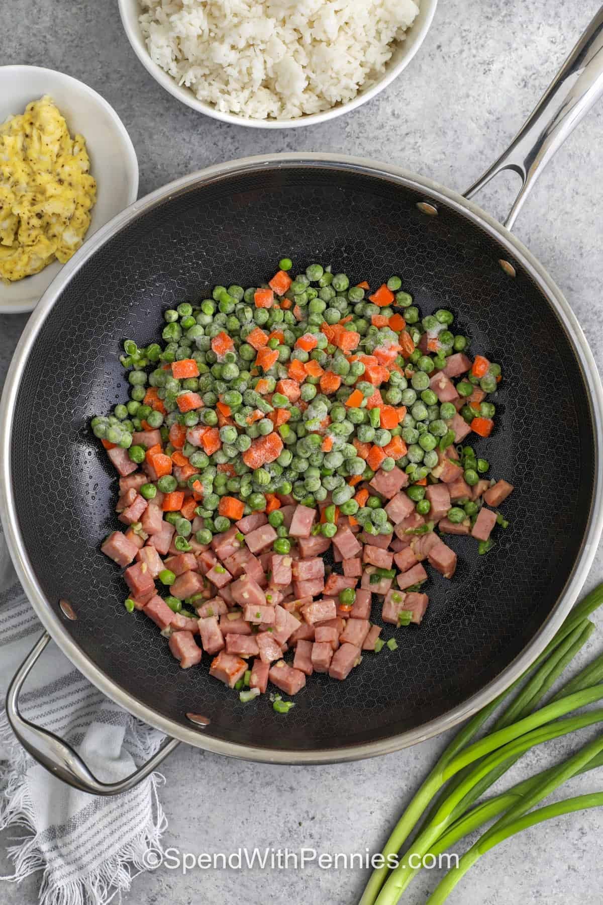 frozen vegetables and ham in a skillet