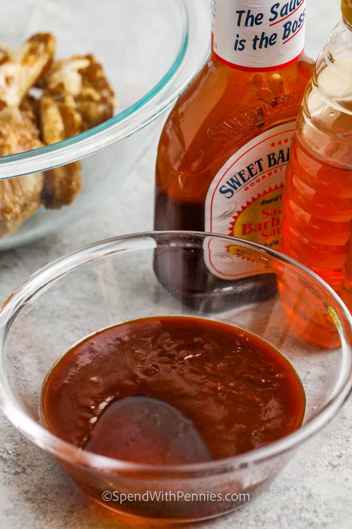 adding bbq sauce and honey together to make sauce for Honey BBQ Wings