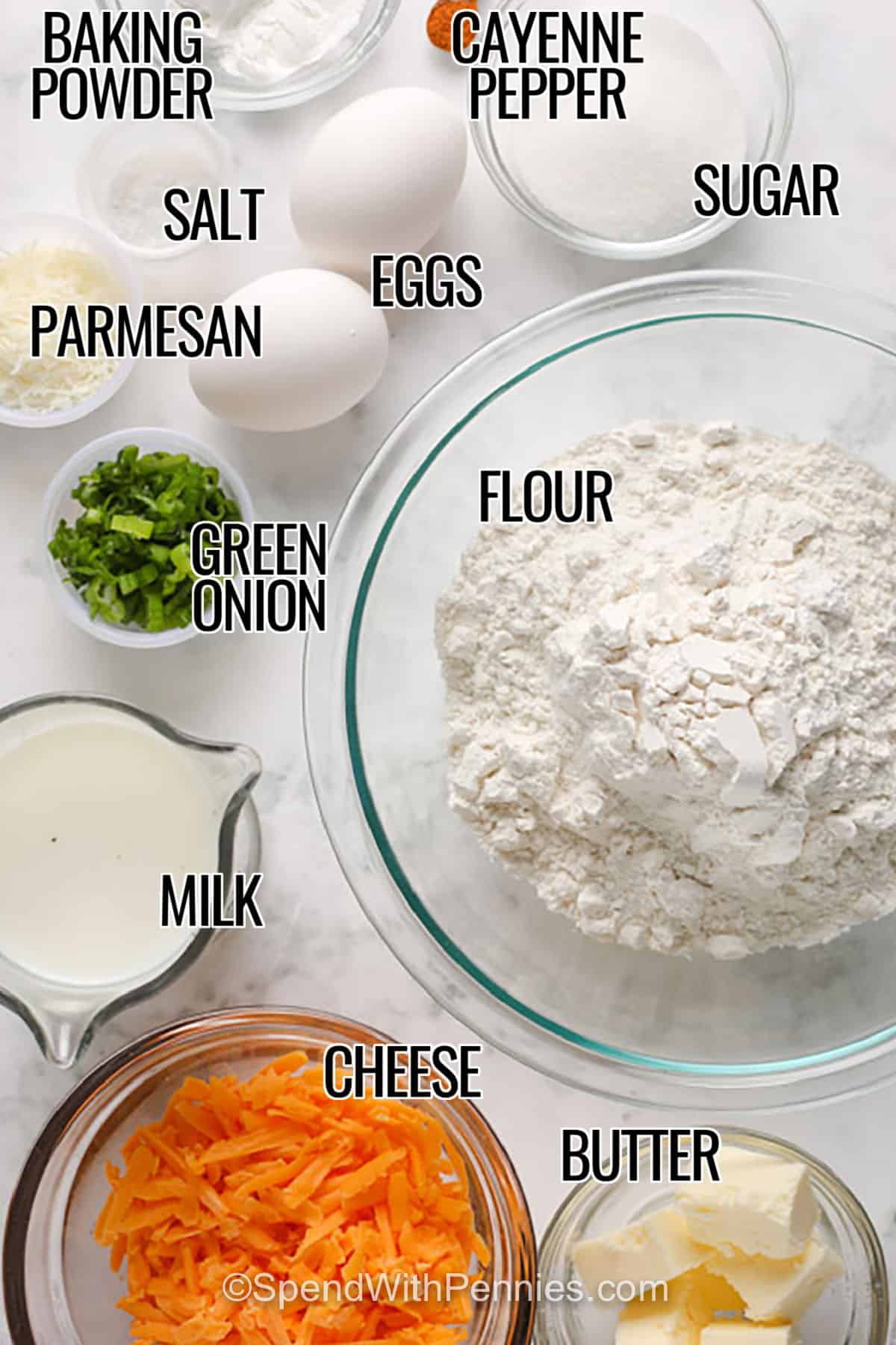 baking powder , cayenne pepper , sugar , eggs , salt , parmesan , flour , green onion , milk , cheese and butter with labels to make Cheese Bread
