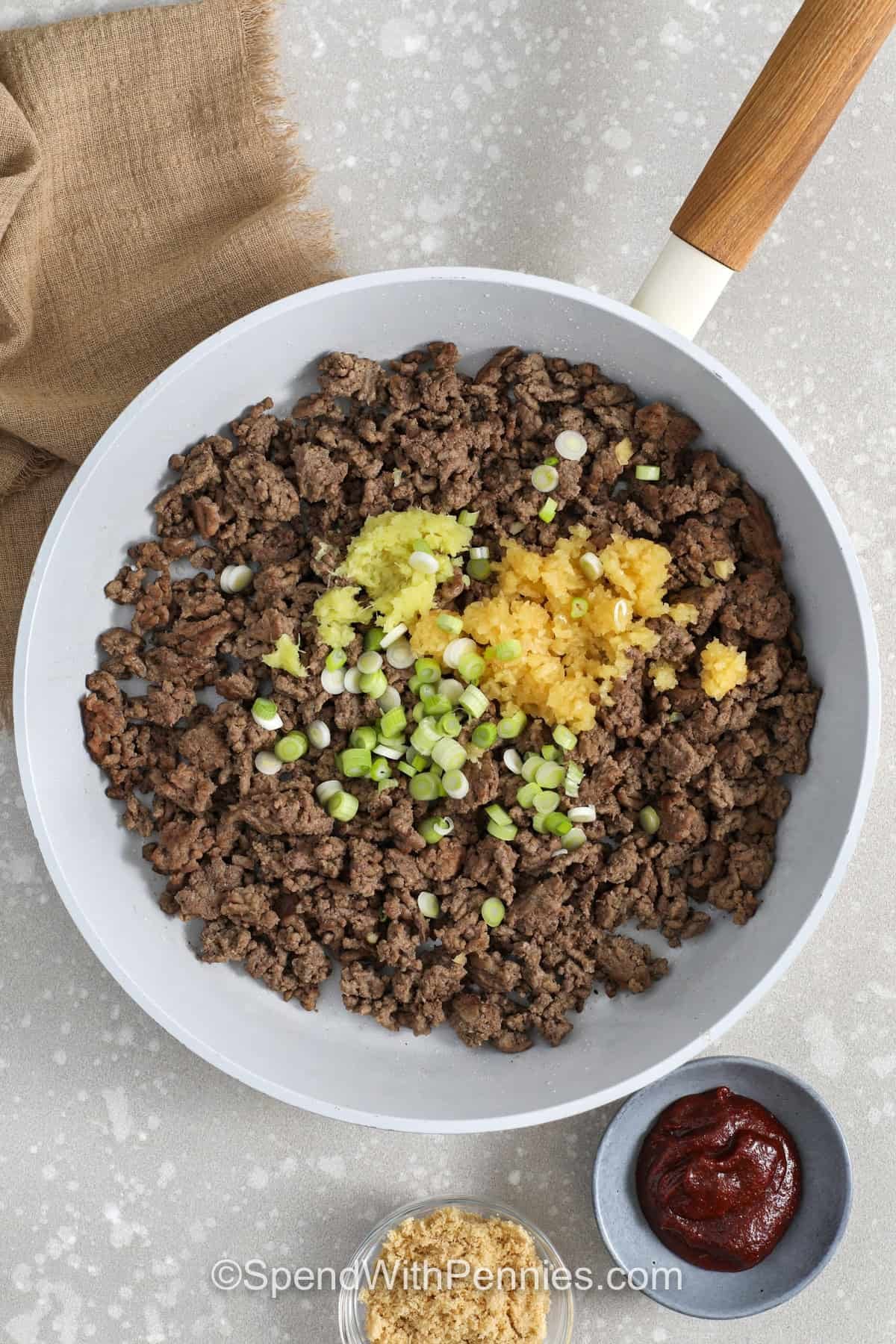 adding garlic and ginger to ground beef to make Korean Ground Beef Bowls