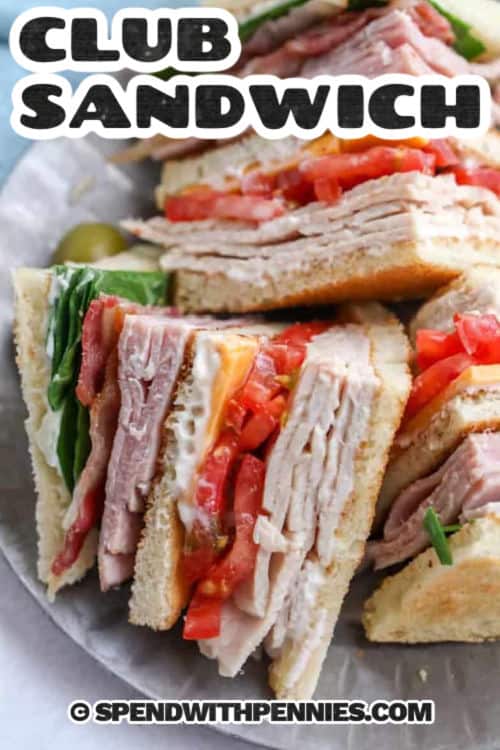This deli-style club sandwich recipe is all about texture and balance: crunchy toast, smoky bacon, savory turkey and ham, and fresh tomato and romaine. Mayonnaise acts as a moisture barrier, helping the sandwich hold together for a clean slice. It is perfect for lunch, casual entertaining, or an easy dinner paired with oven fries, potato salad, or crunchy pickles. #spendwithpennies club sandwiches on a plate with writing