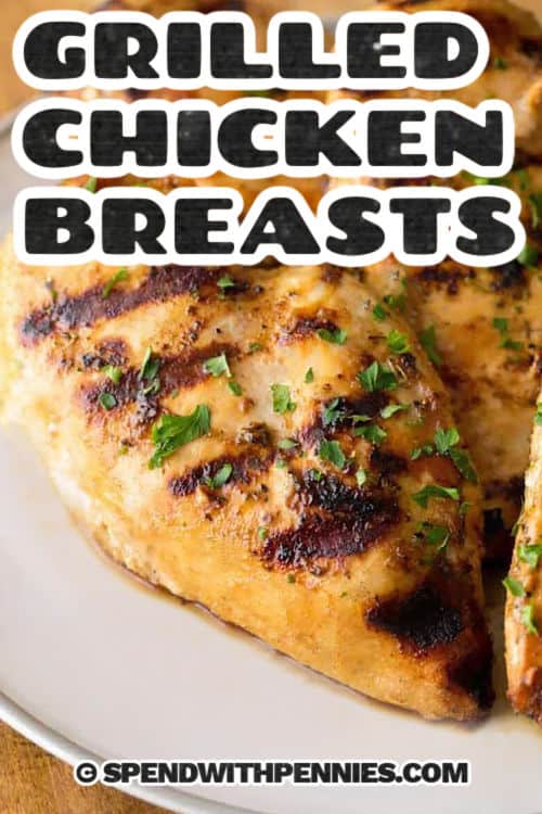 A simple grilled chicken marinade can completely change the texture and flavor of chicken breasts, and this one is a keeper. Lemon juice, Dijon mustard, and Italian seasoning bring a balanced mix of tangy, savory, and herby notes. This recipe is especially useful for anyone who wants grilled chicken that works in salads, sandwiches, tacos, and other quick meals. #spendwithpennies grilled chicken breasts on a white plate with writing