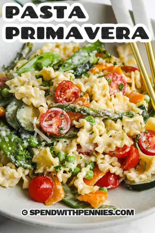 pasta primavera in a white bowl with writing