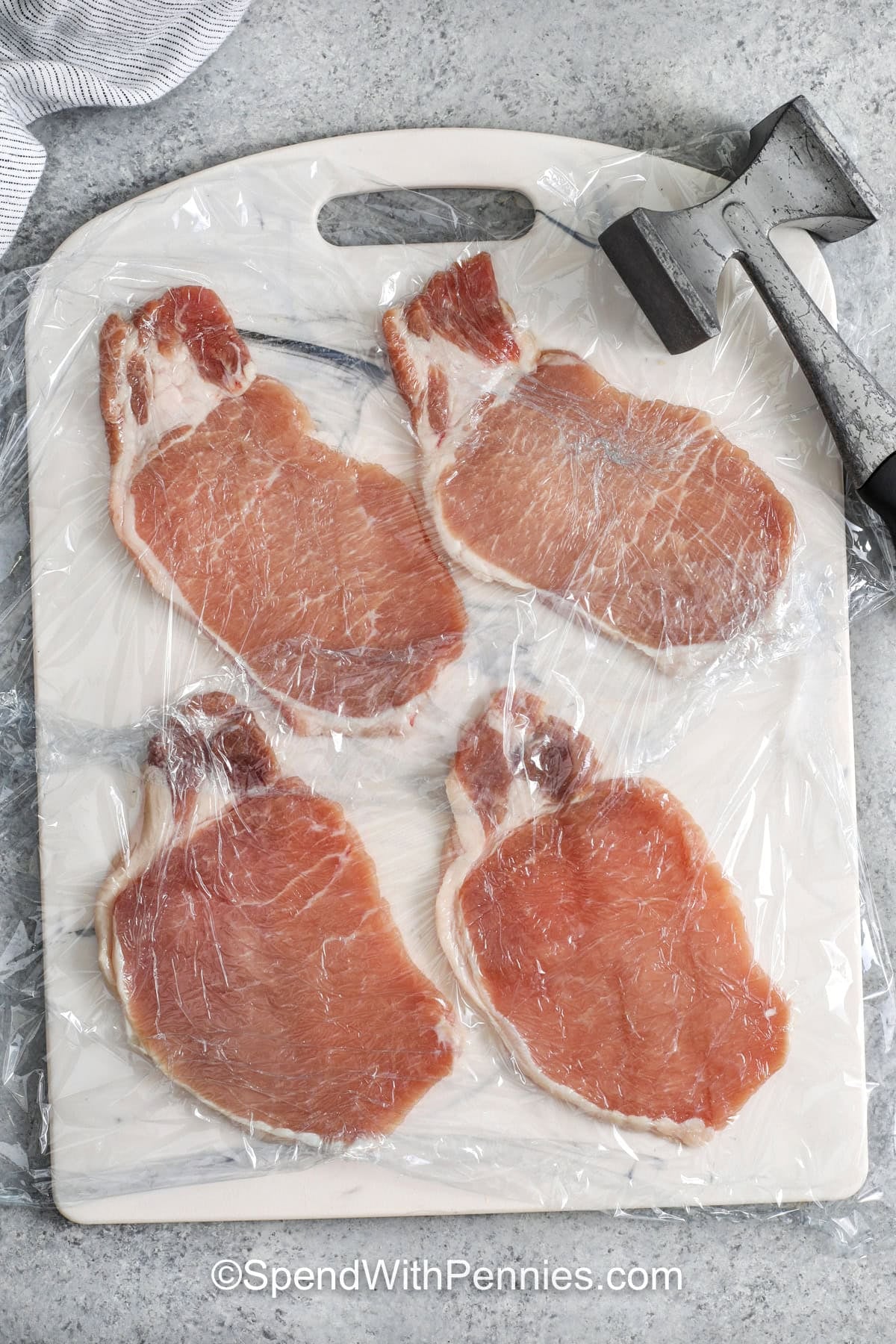 flattening pork chops to make Pork Cutlets