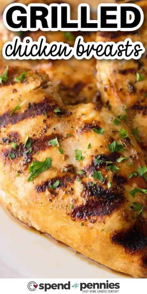 Juicy grilled chicken breasts are easier than they seem when the marinade does the work for you. This version uses Dijon mustard, Italian seasoning, and lemon for bright flavor, then cooks quickly over medium-high heat. The chicken is great for meal prep because it slices well and fits into wraps, grain bowls, pasta salads, and simple family dinners. #spendwithpennies grilled chicken breasts on a plate with writing