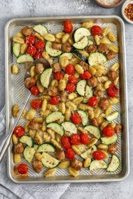 sheet pan of Sheet Pan Gnocchi & Sausage with a spoon