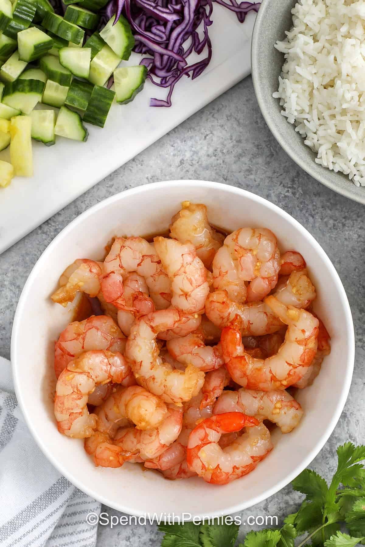 shrimp being marinated in a bowl