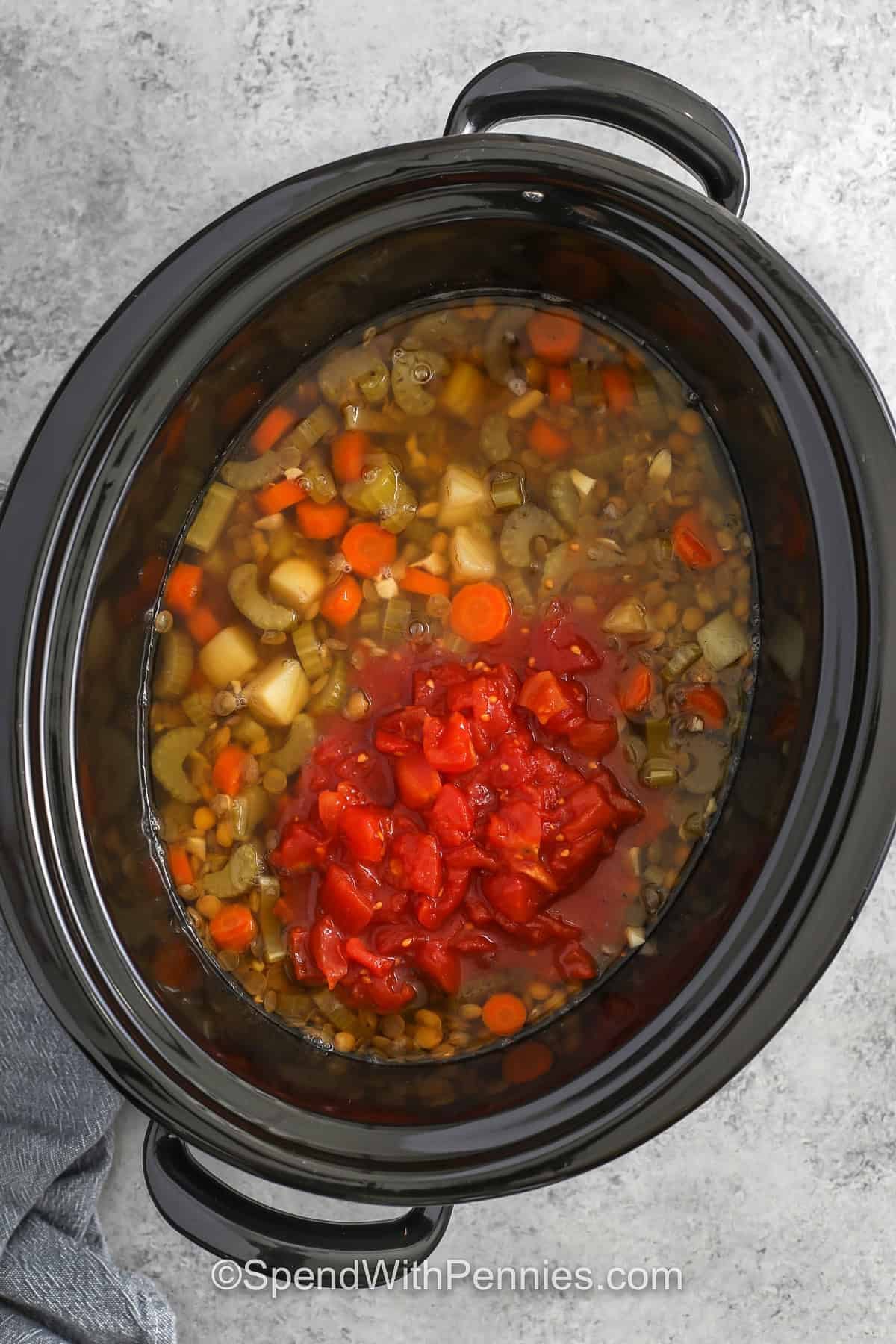 adding ingredients to pot to make Slow Cooker Lentil Soup