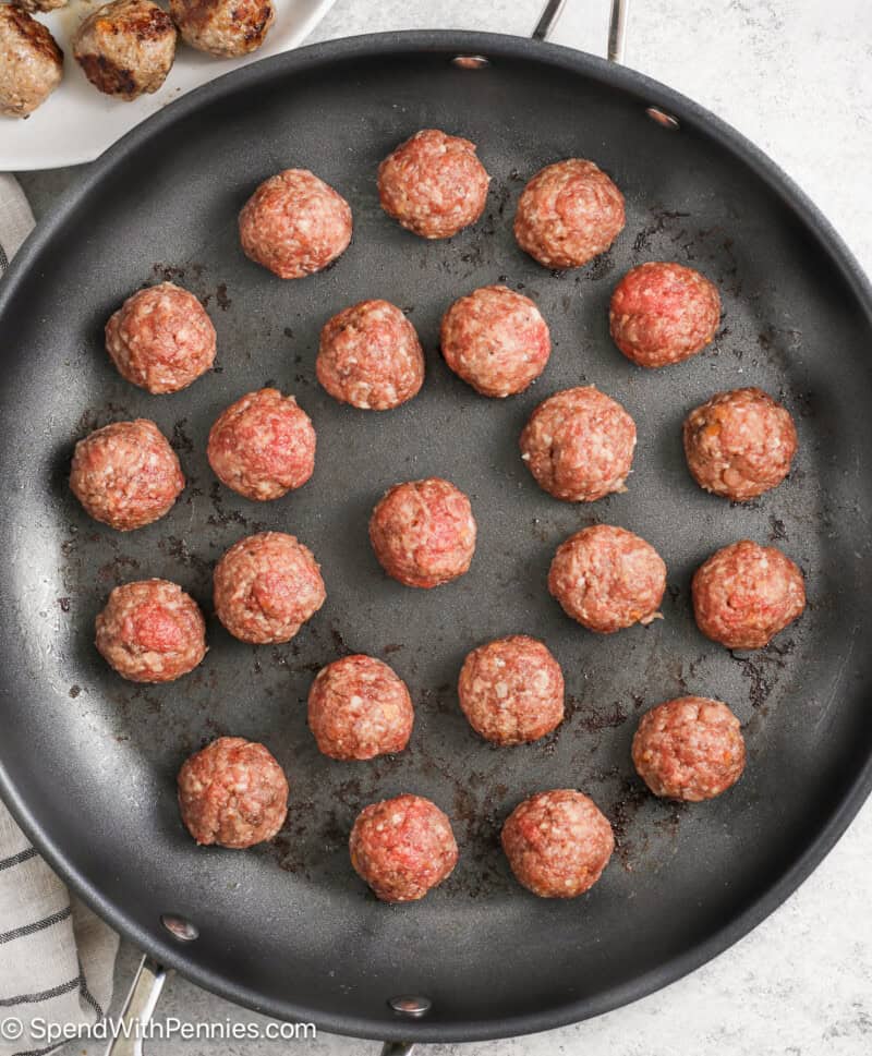Browning meatballs in a skillet for Swedish meatballs