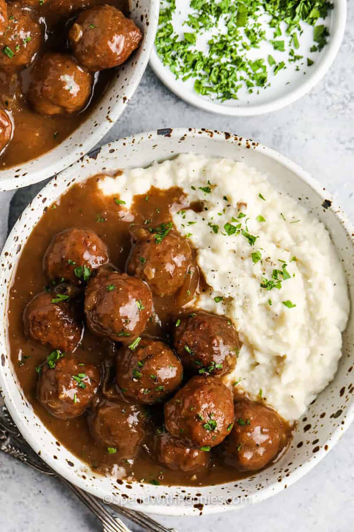 Slow cooker meatballs and gravy are an easy shortcut, recipe that turns them into a true comfort food dinner. The combination of beef broth, French onion soup, sautéed onions, and heavy cream builds a rich gravy with very little effort. This is a smart recipe for meal prep, leftovers, and nights when you want a filling dinner without much hands-on cooking. #spendwithpennies Slow Cooker Meatballs on mashed potatoes