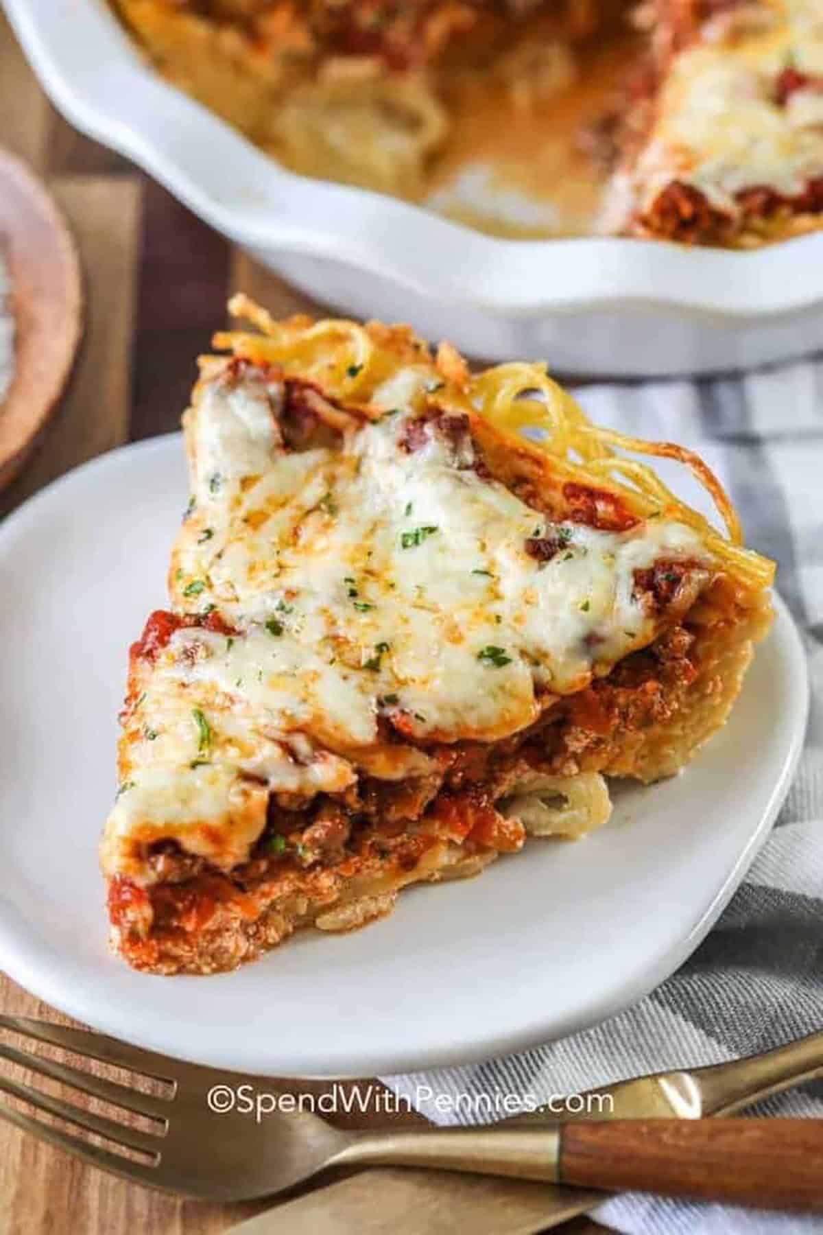 cheesy slice of Spaghetti Pie on a plate