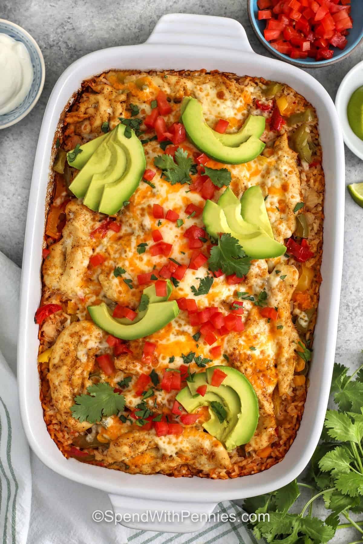 This cheesy chicken fajita casserole takes the familiar flavor of fajitas and turns it into a warm baked dinner that is easy to assemble. Salsa and broth season the rice while the chicken cooks above it, helping every bite pick up extra flavor. It is a great way to use basic ingredients and still end up with something comforting, colorful, and worthy of repeating on busy nights. #spendwithpennies top view of Chicken Fajita Casserole