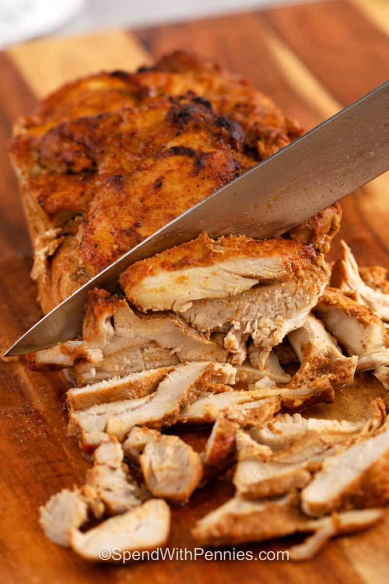 slicing stack of chicken to make Chicken Shawarma