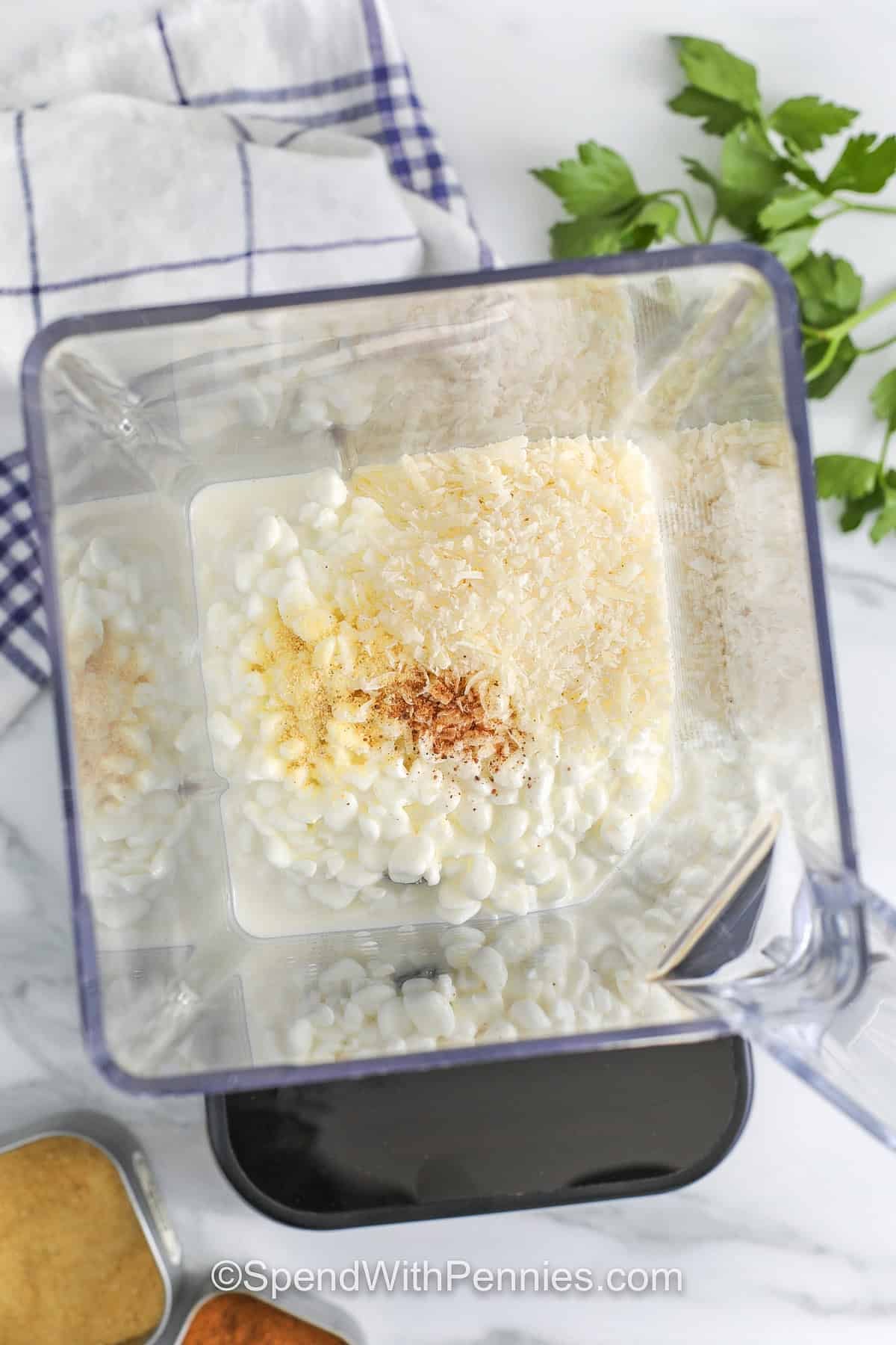 adding ingredients to blender to make Cottage Cheese Alfredo Sauce