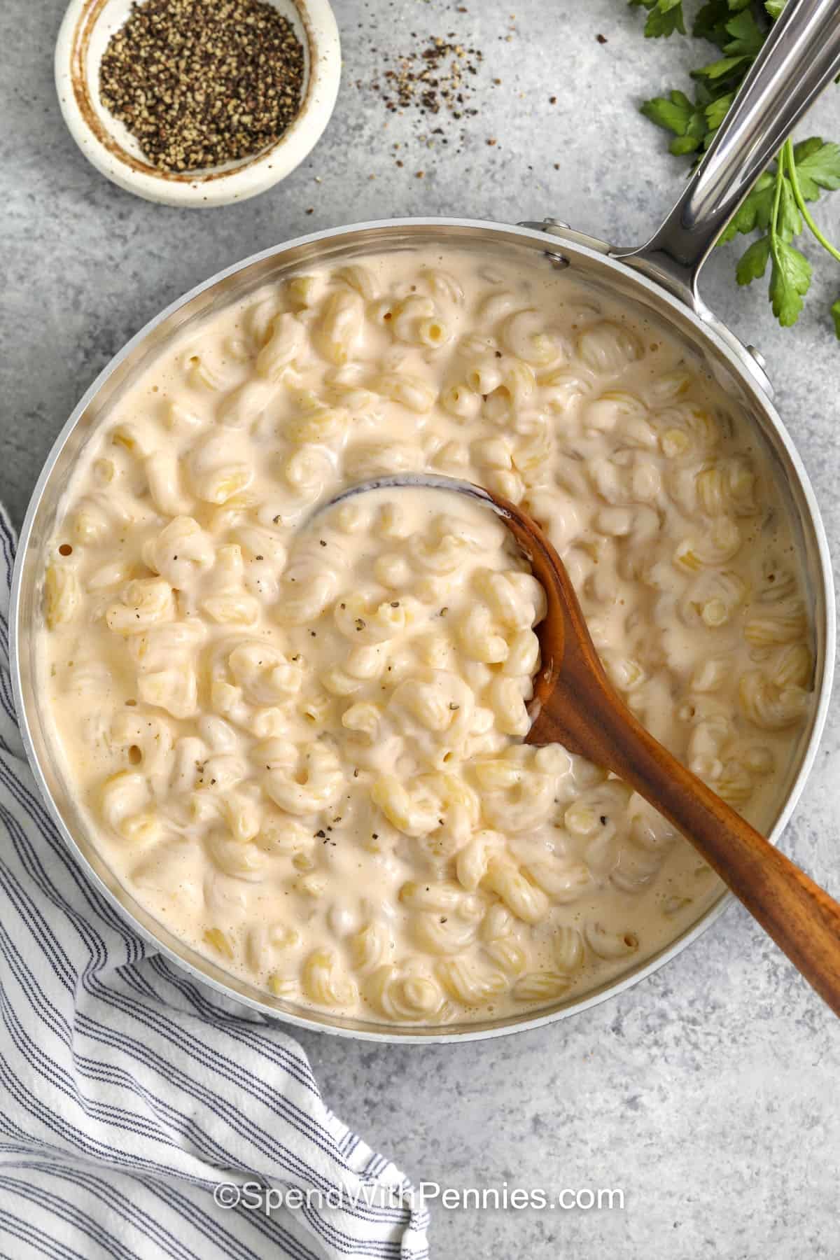 Cottage Cheese Mac and Cheese in a pot with a wooden spoon